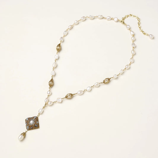 Elegant 14K gold plated necklace with freshwater pearls and ornate crystal diamond pendant on cream background.
