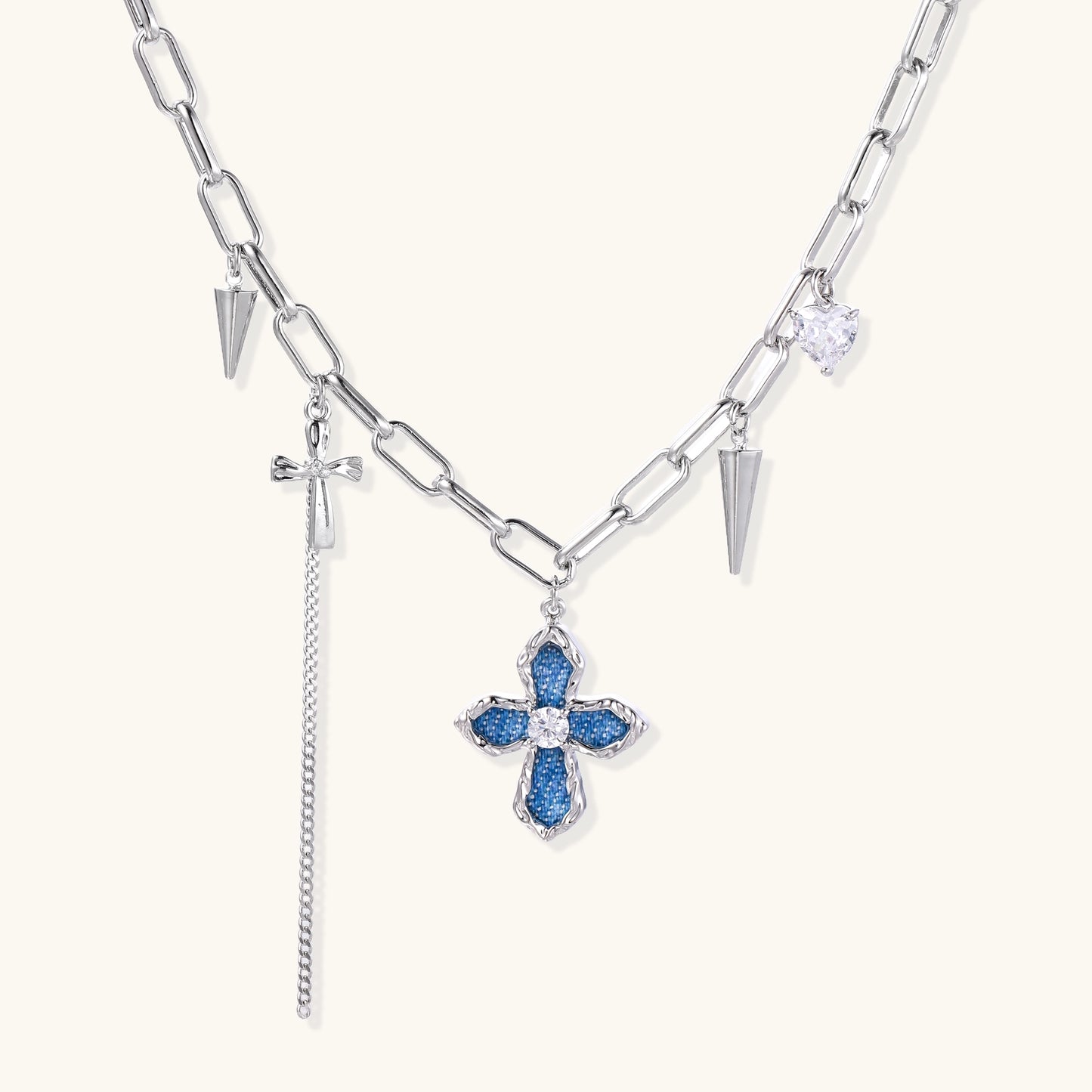 18K gold plated brass chain necklace featuring blue cross pendant with zirconia center stone and spike charms on white background.