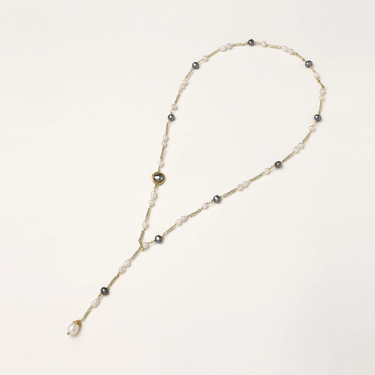 Long gold-plated necklace with alternating white and gray freshwater pearls spaced along delicate chain segments