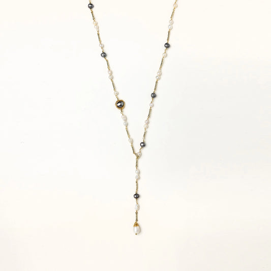 Long gold-plated necklace with alternating white and gray freshwater pearls spaced along delicate chain segments