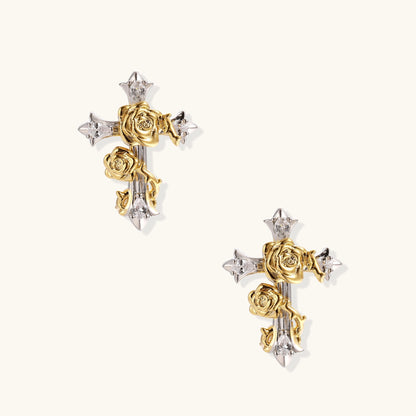 Two-tone cross earrings with gold roses and silver base featuring crystal accents on beige background.