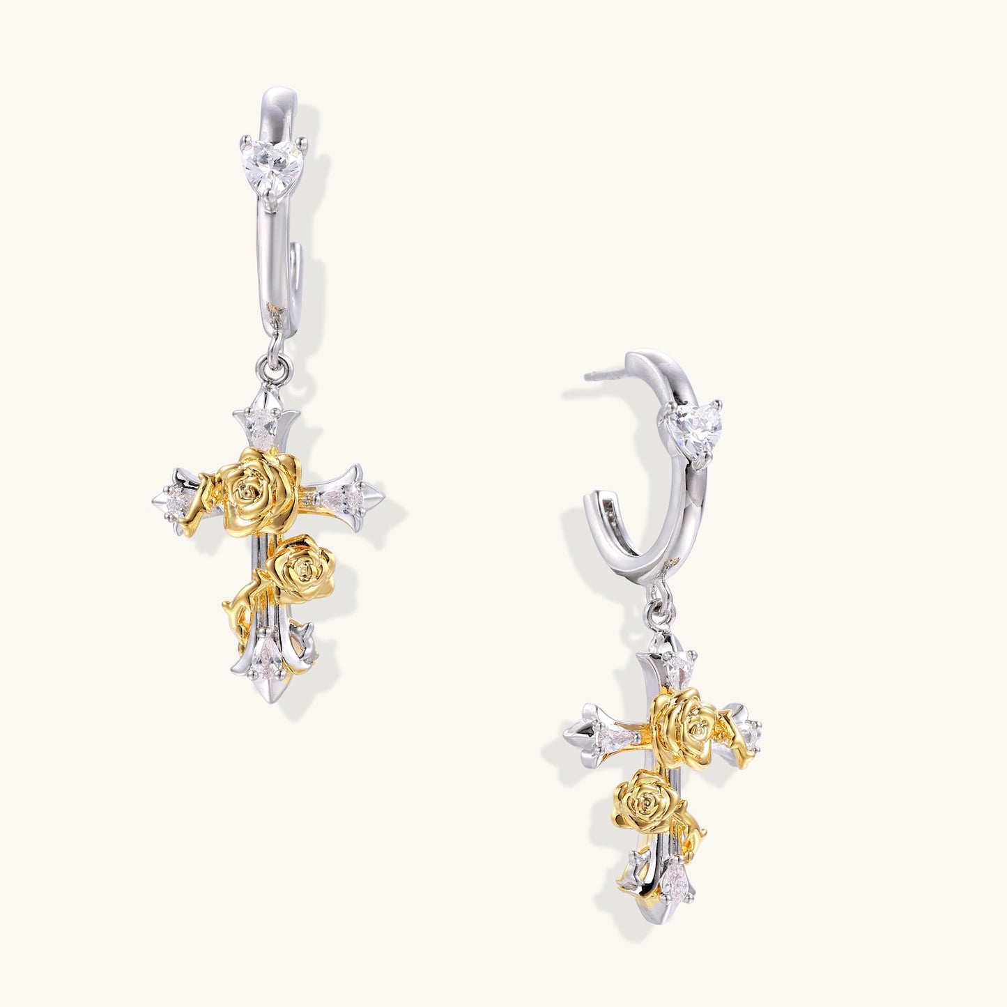 Ornate cross-shaped dangle earrings with gold roses and sparkling zirconia stars on silver-toned base with hoop closures.