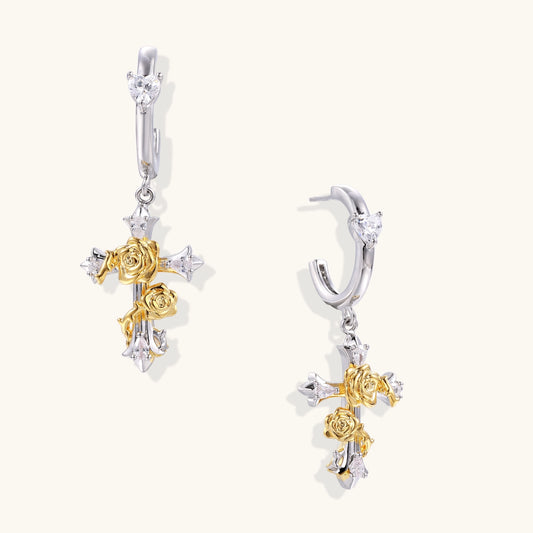 Ornate cross-shaped dangle earrings with gold roses and sparkling zirconia stars on silver-toned base with hoop closures.