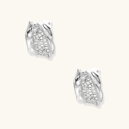 Small gold-plated brass hoop earrings with geometric lattice pattern and zirconia accents on white background.