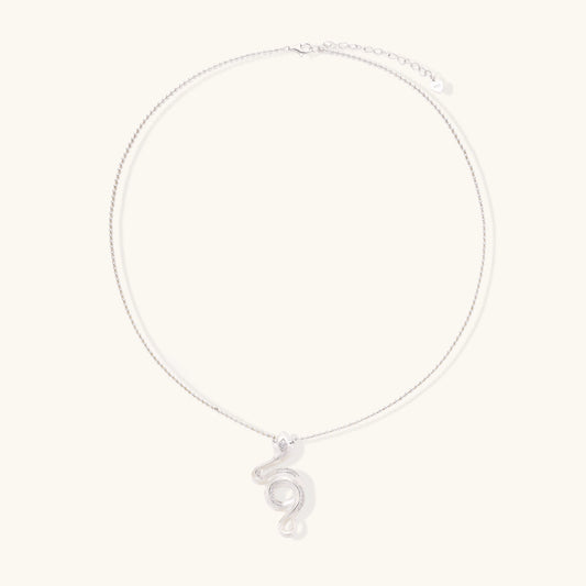 Sterling silver snake pendant necklace with zirconia crystals on adjustable chain against cream background