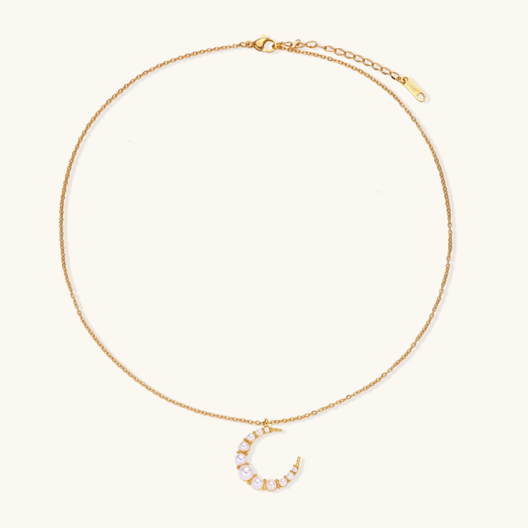 Delicate 18K gold plated necklace featuring crescent moon pendant with white shell pearl beads on neutral background.