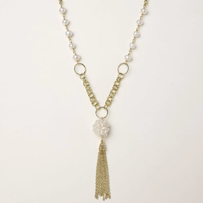 Long gold-plated necklace with freshwater pearls, chunky chain links, and flowing tassel pendant