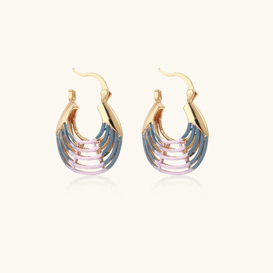 Gold hoop earrings with gradient blue-to-pink enamel in ribbed fan design on beige background