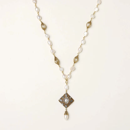 Y-shaped necklace with freshwater pearls, gold filigree stations, and ornate diamond-shaped centerpiece with pearl drop