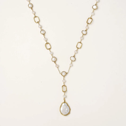 Long gold-plated necklace with alternating freshwater pearls and crystal bezels, featuring a large baroque pearl pendant