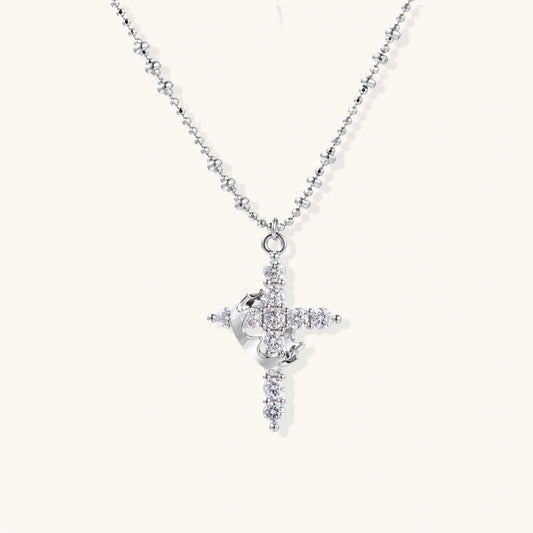 White gold-plated cross pendant adorned with sparkling zirconia stones and crescent moon accent on ball chain