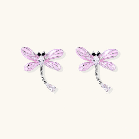 Long drop earrings with translucent lavender enamel dragonfly wings and white gold plated segmented bodies on white background