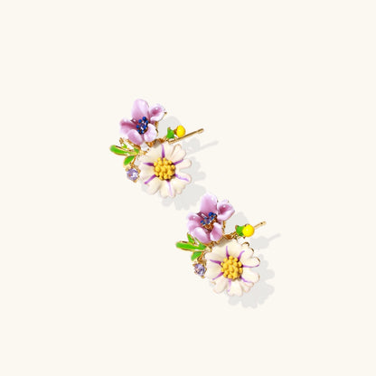 Cluster-style stud earrings with purple pansies, white daisies, yellow centers, and green leaves in glossy enamel finish