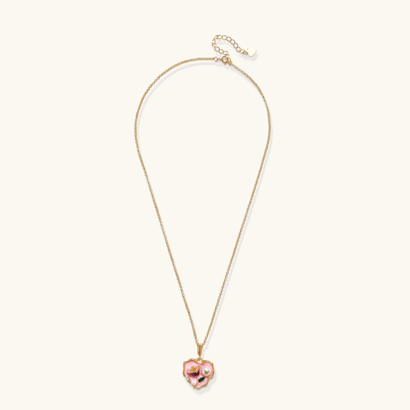 Heart-shaped pendant with pink enamel, rose design, freshwater pearl flower, and gold scalloped frame on delicate chain