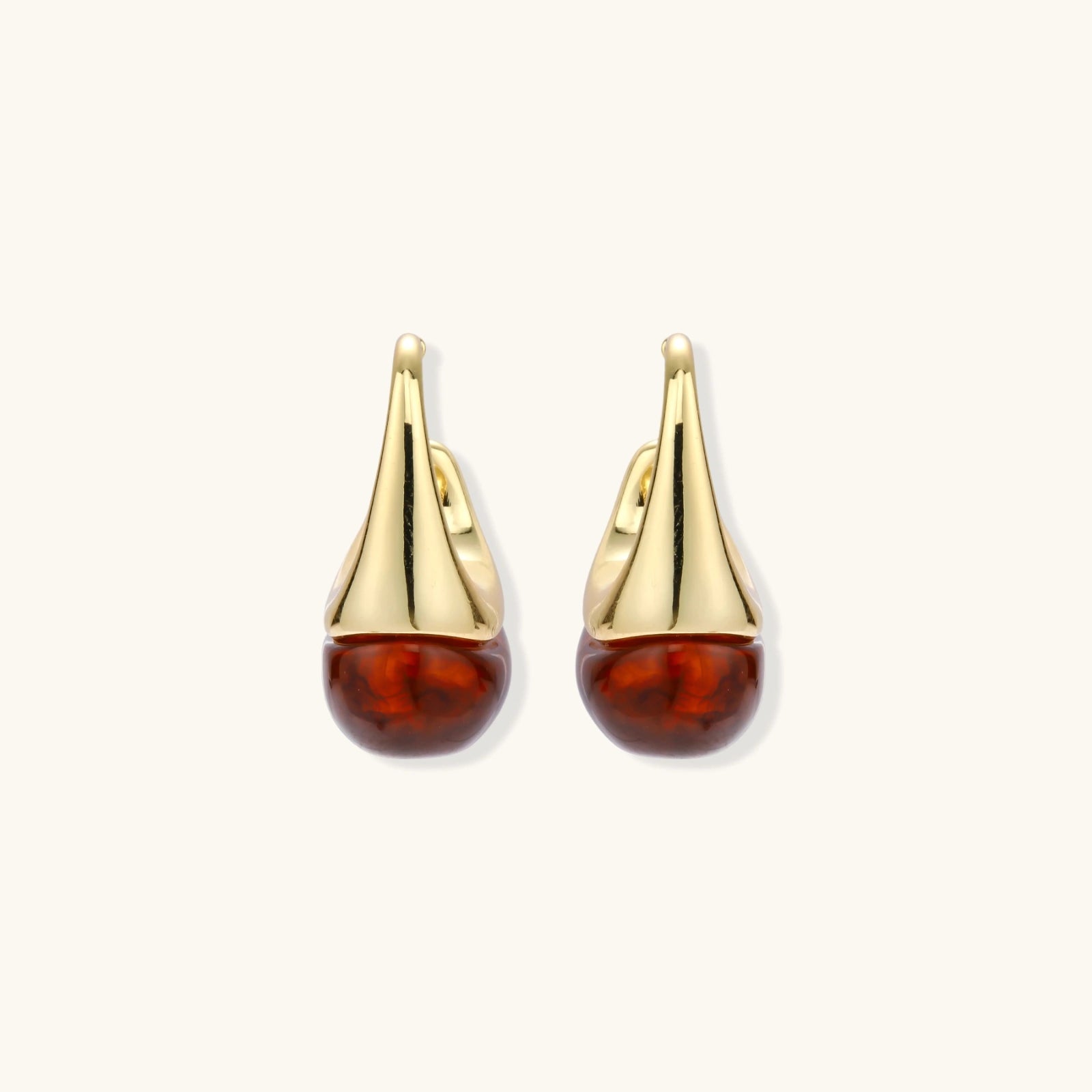 Modern drop earrings with curved gold-plated copper tops and amber resin bottoms creating an organic teardrop silhouette.