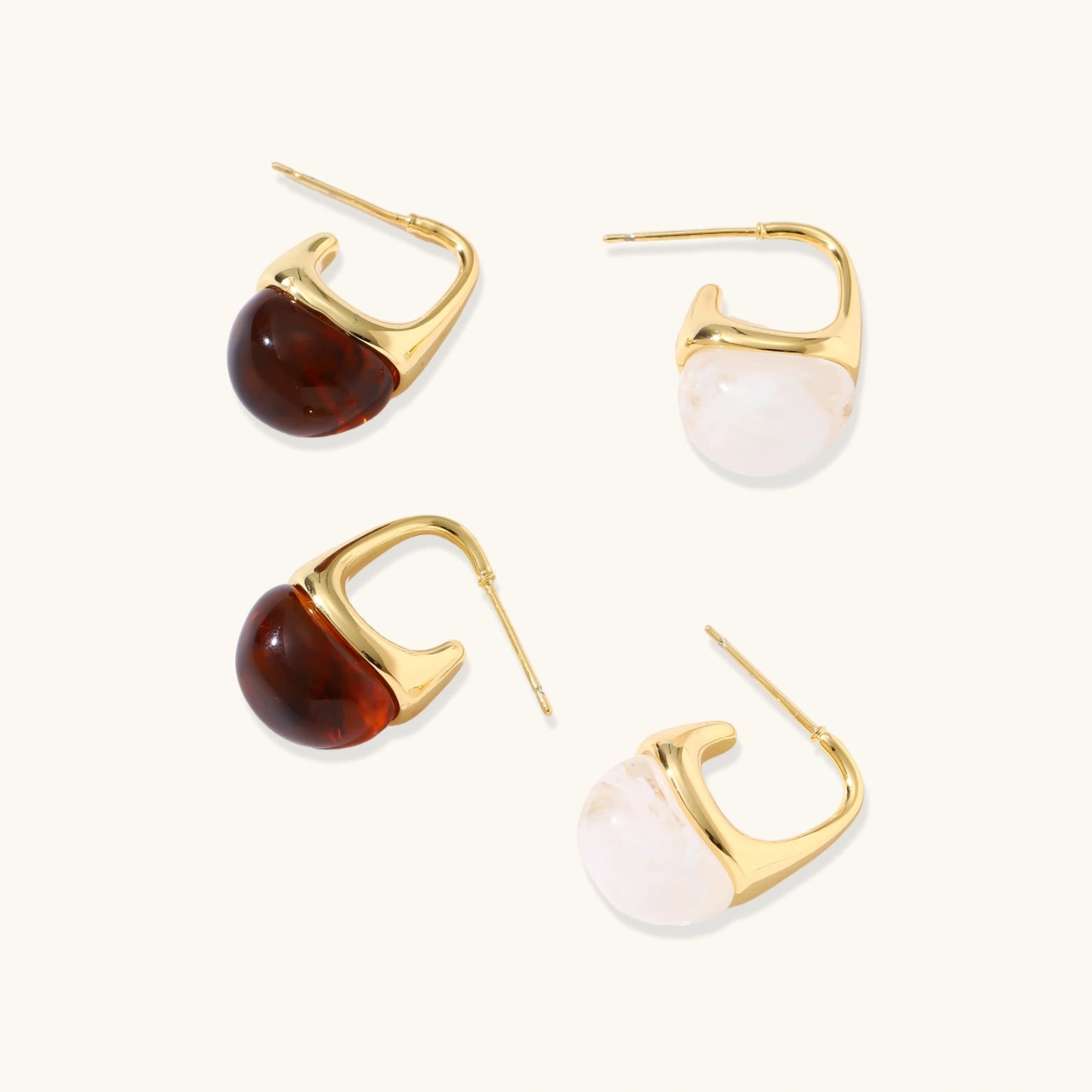Modern drop earrings with curved gold-plated copper tops and amber resin bottoms creating an organic teardrop silhouette.