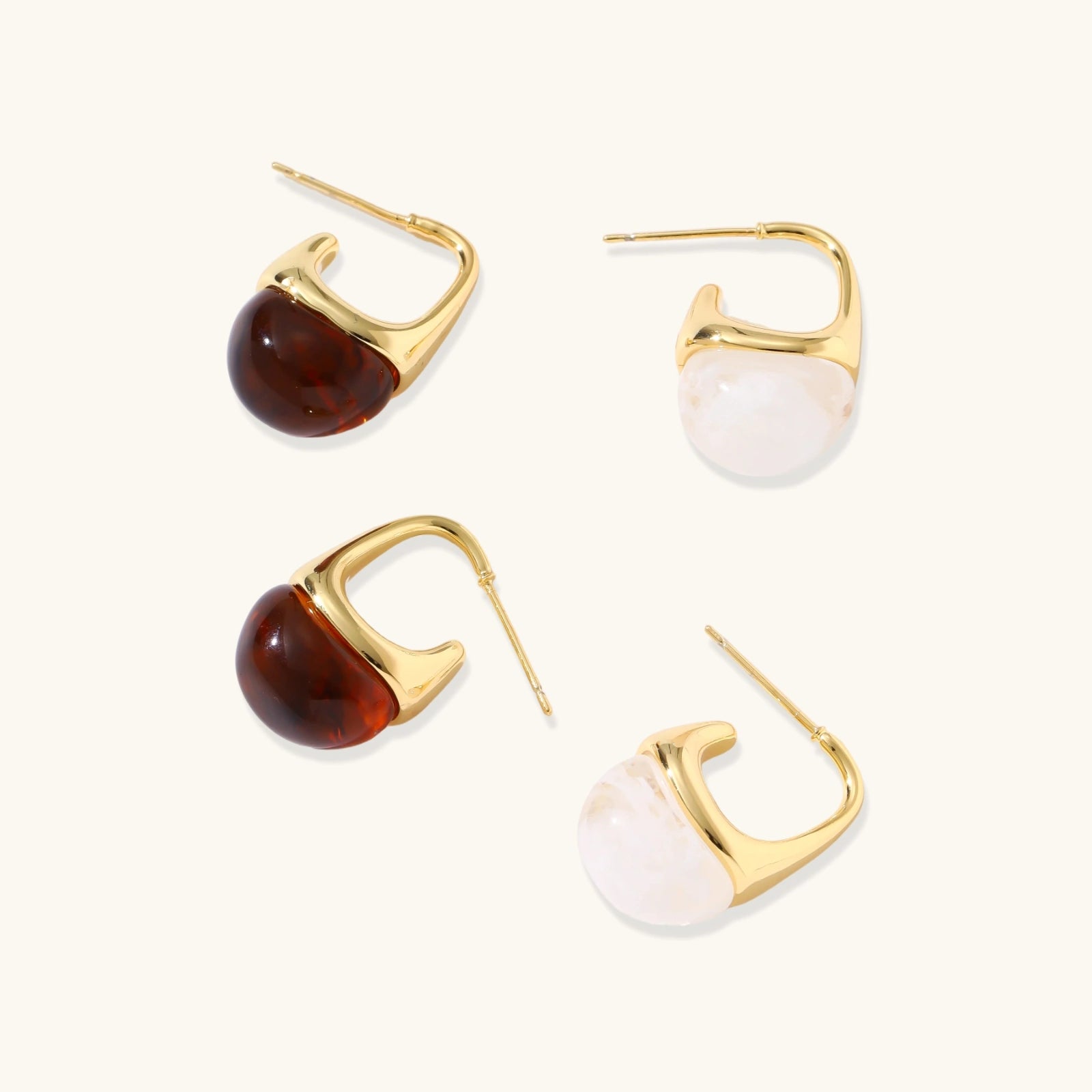 Modern drop earrings with curved gold-plated copper tops and amber resin bottoms creating an organic teardrop silhouette.