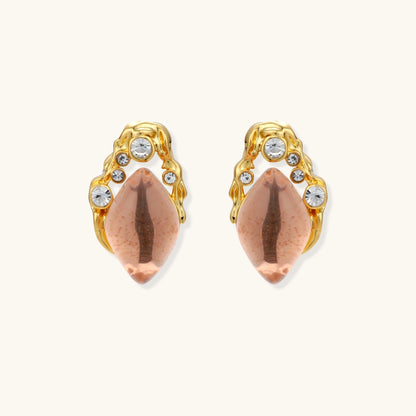 Gold-plated baroque stud earrings with coral-pink liuli stones and cubic zirconia crystals on white background.