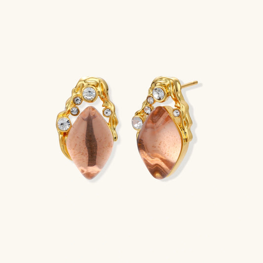 Gold-plated baroque stud earrings with coral-pink liuli stones and cubic zirconia crystals on white background.